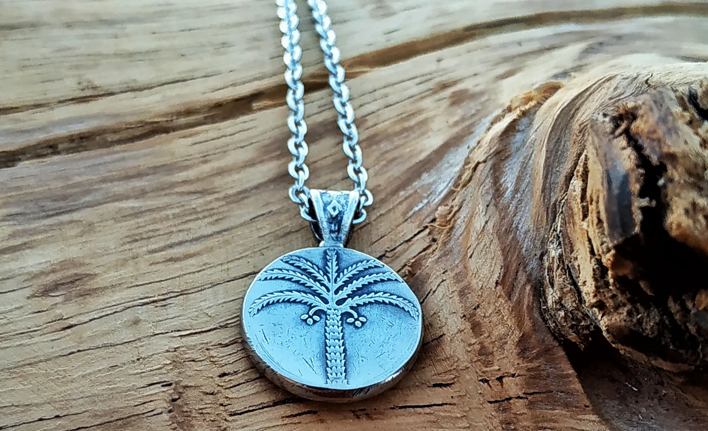 תליון עץ תמר, 100 פרוטה - מהמטבעות הראשונים של ישראל